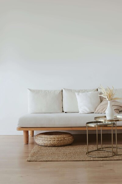 White sofa in a clean living room space that is boho inspired