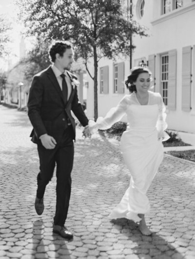 alys beach couple bride groom running in street  Wedding Venue Destination Wedding Photographer