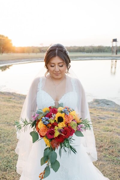 Bride holding colorful bouquet