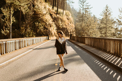 girl standing on road bridge in columbia river gorge