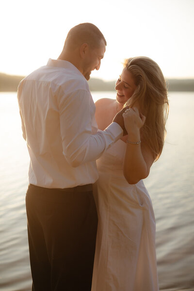 engagement session man spinning woman around in the water