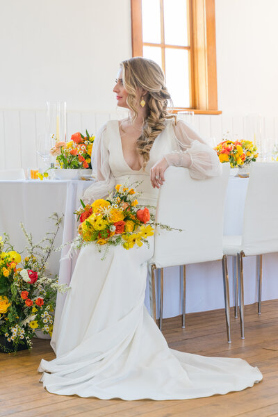 The Chapel Company - Intimate Wedding - Bride Sitting on chair looking out the window