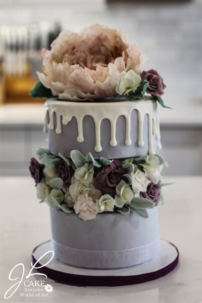 luxury wedding cake with sugar flowers and drip