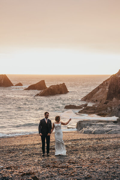 Bride's veil blows away on a windy beach