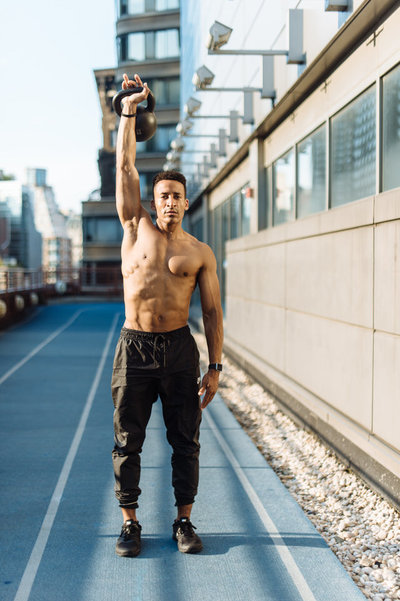 man holding a kettlebell straight up