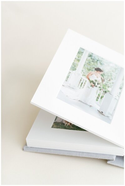 Handcrafted folio album shown open to display photo layout and premium paper quality