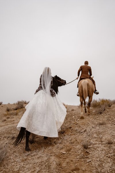 Couple horseback riding at their Amangiri wedding