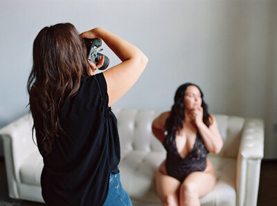 Alex Blair taking photos during boudoir session