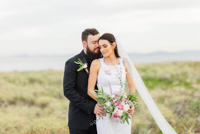 newly weds on mackay beach during their portraits as mr and mrs