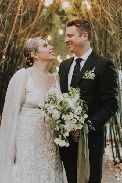 Jessica and Branden staring at each other lovingly after getting married (accompanied by an incredible Molly in the Sky Bouquet btw.