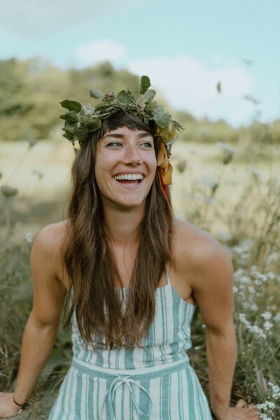 woman laughing with leaf crown