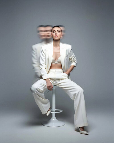 Jasmina Kimova in motion wearing a white suit, symbolizing reinvention, mastery, and visionary brand evolution.
