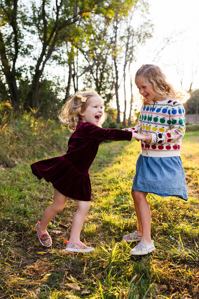 Fall family throwing leaves in air for Twin Cities Family Photographer