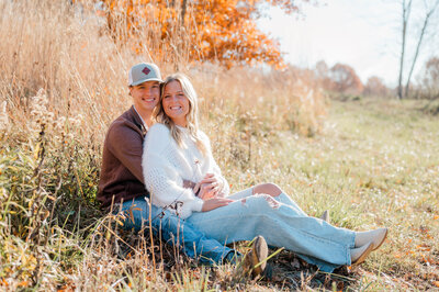 A couple poses for the camera with man caressing woman's face.