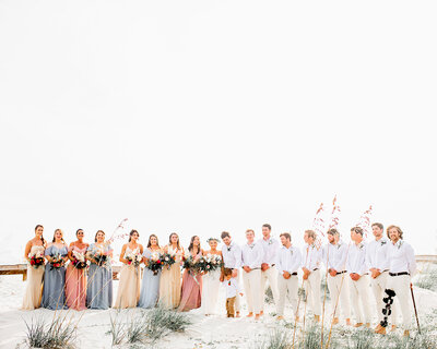 Wedding Part poses on the beach