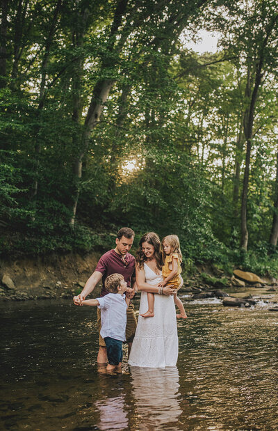 Family in creek near forest at Jerusalem Mill Baltimore Maryland