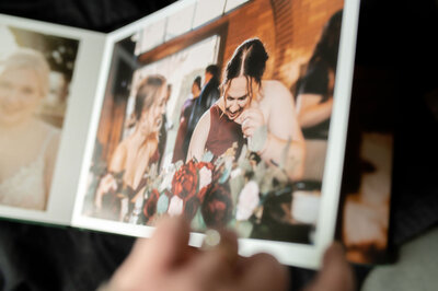paging through luxury wedding photo album with high-quality images