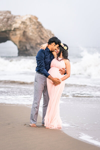 Pregnant woman wearing orange dress for her maternity photo session in SF
