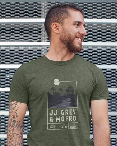 T-shirt graphic design for JJ Grey & Mofro featuring a moonlit river scene with palm trees, custom typography, and Southern rock-inspired layout.