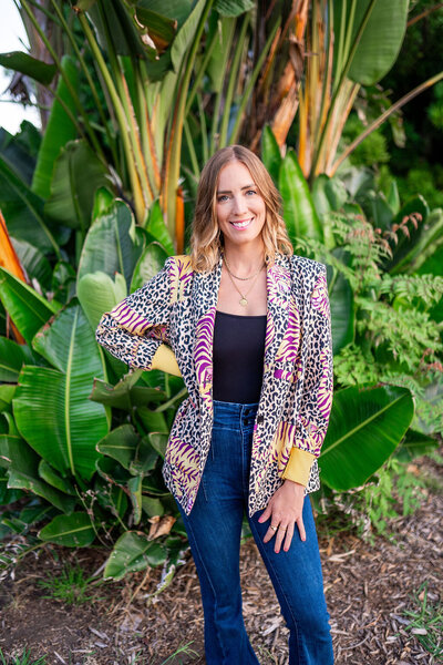 Showit designer standing outside in from of tropical plants - Create & Wander