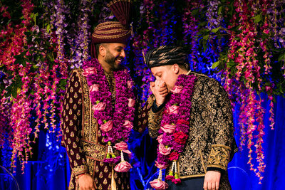 one groom kissing the other groom's hand