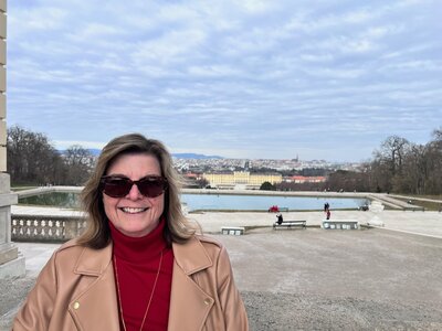 Photo of Kelly smiling while traveling