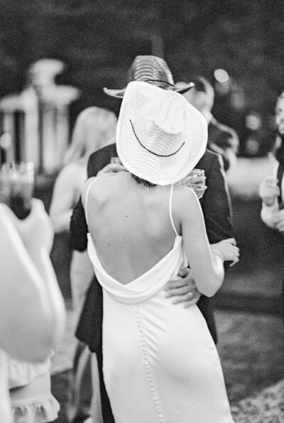 bride and groom wearing cowboy hats