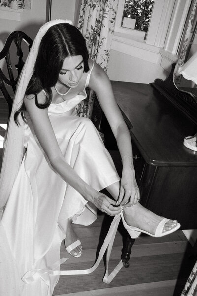 bride getting ready and putting on shoes
