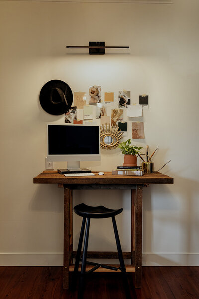 computer desk against white wall