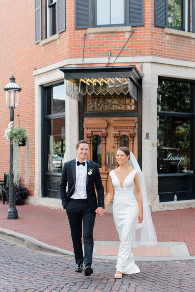 bride smiling at camera with groom smiling at bride photographed by northwest wedding photographer ashleigh grzybowski