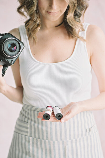 Kahla Kristen Photography holds two rolls of film in her hands