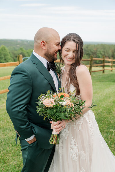 Groom in olive green suit nuzzled up to his giggling bride