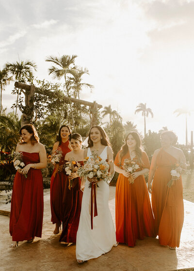 Bianca and her bridesmaids walking together at sunset ready for the wedding.