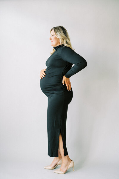 mom to be brushing her hair back during studio maternity photos