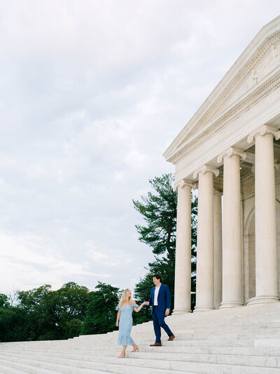 Photo of couple walking down the steps at the Jefferson Memorial for their DC engagement session