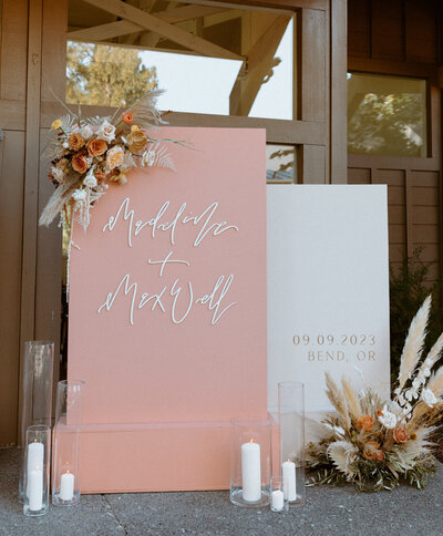 Custom calligraphy wedding welcome sign featuring florals, pillar candles at an Oregon wedding venue representing full service design and calligraphy by Life in Letters.