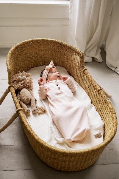 mom and dad kiss newborn baby boy in dallas texas home photo session
