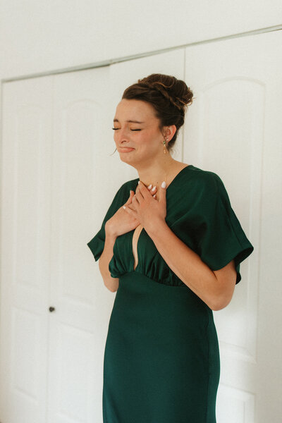 Brunette woman emotional as she sees her sister as a bride