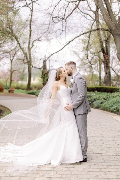bride and groom kissing at spring garden in philadelphia