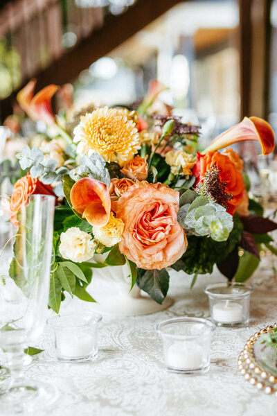 orange roses and yellow flower centerpieces