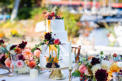 3 tiered cake with figs and blackberries and burgundy dahlias