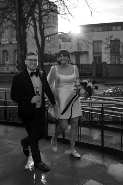 Wedding photographer captures couple taking a stroll hand in hand at their french chateau wedding.