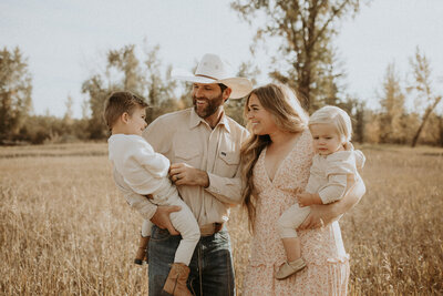 photo of family playing in an open field in montana