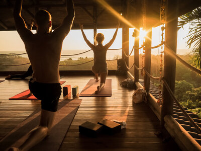 Yoga class during sunrise in a wellness resort retreat