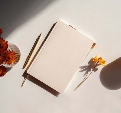 journal on  a white desk