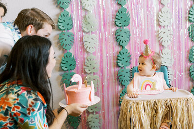 Parents and baby doing first birthday smash cake at party planned by Bianca Nichole and Co