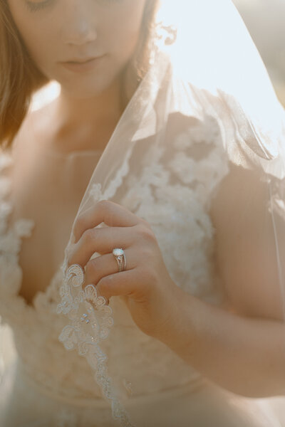 romantic photo of bride with veil and ring