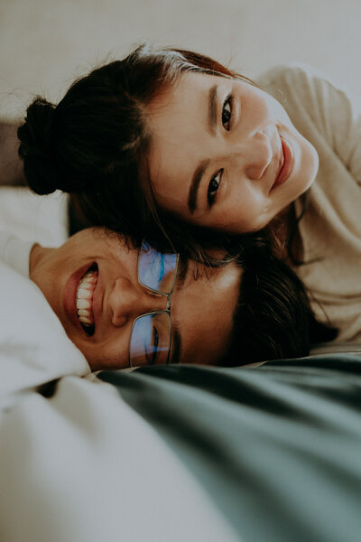 couple laying down and smilling