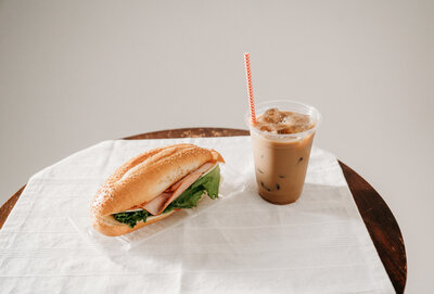 sandwich and coffee sitting on table