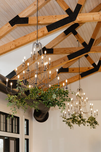 picture of flower arrangements on light fixtures in wedding reception venue